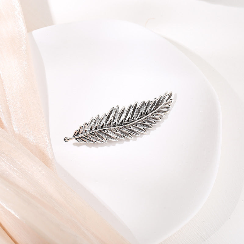 Metallic feather hair barrette