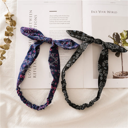 Multi-coloured paisley print elastic headband with bow