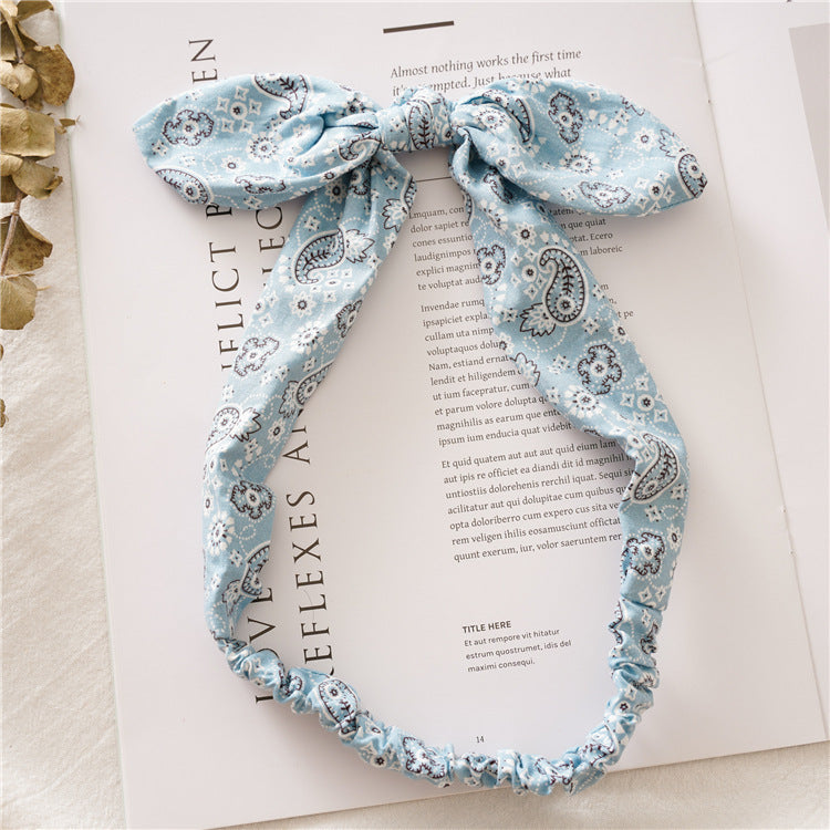 Multi-coloured paisley print elastic headband with bow