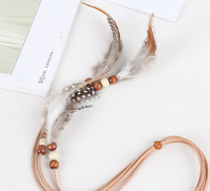 White spotted feather brown hair tie