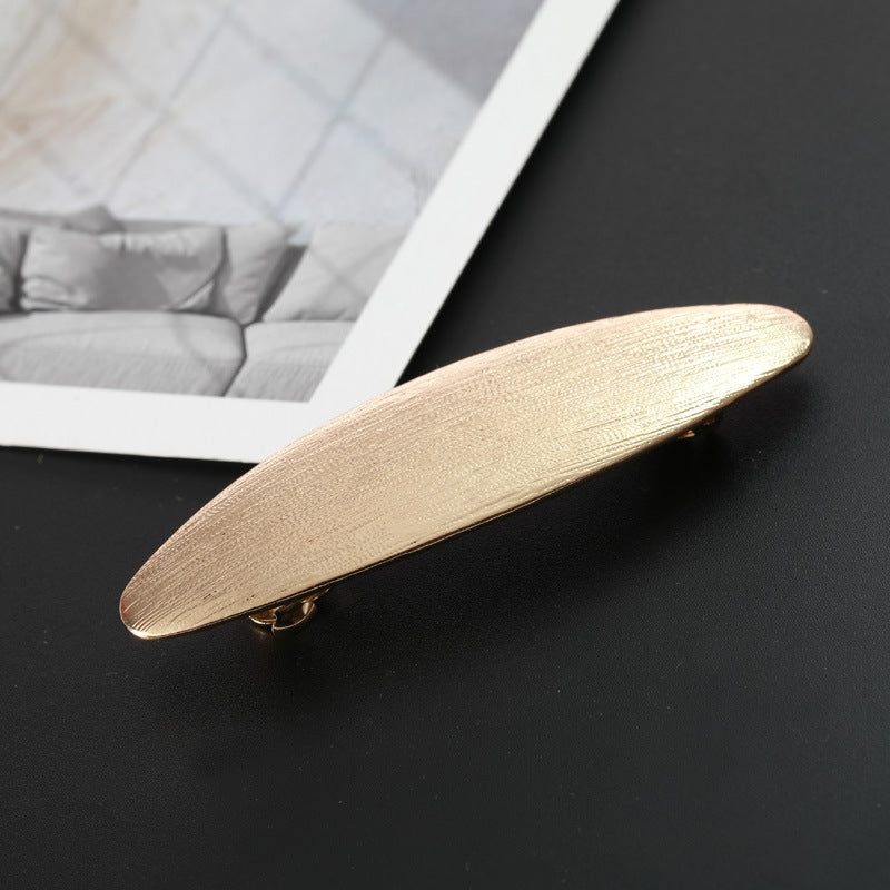 Flat oval barrette in brushed metal
