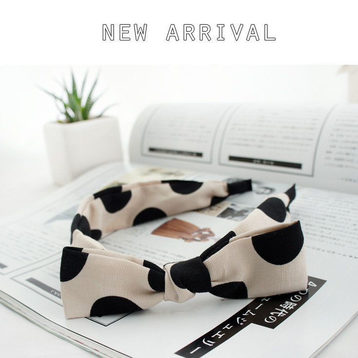 Black polka dots on cream coloured headband with bow