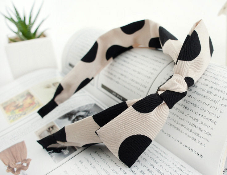 Black polka dots on cream coloured headband with bow