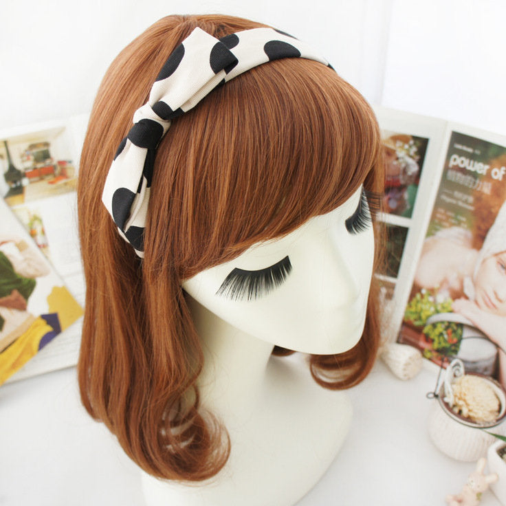 Black polka dots on cream coloured headband with bow