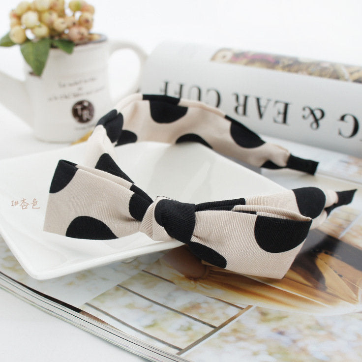 Black polka dots on cream coloured headband with bow