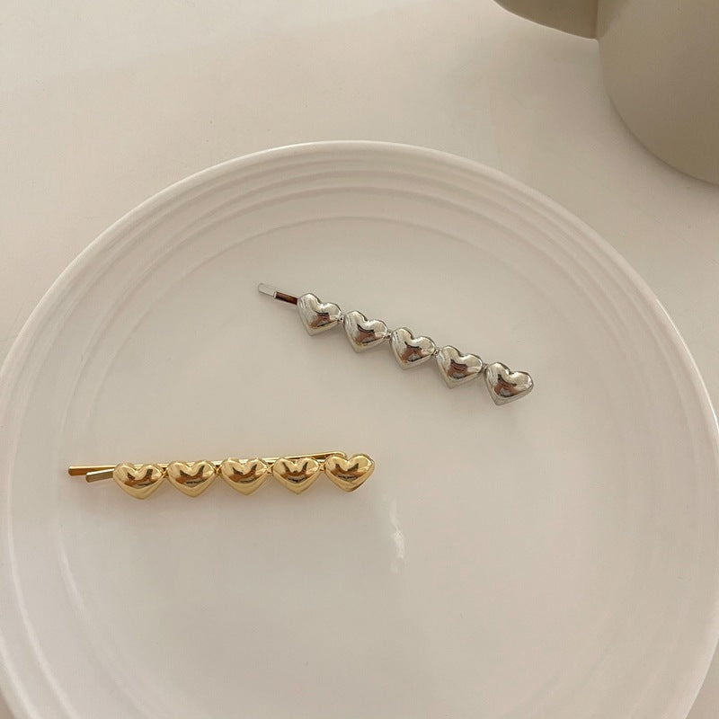 Metallic hearts hair slide
