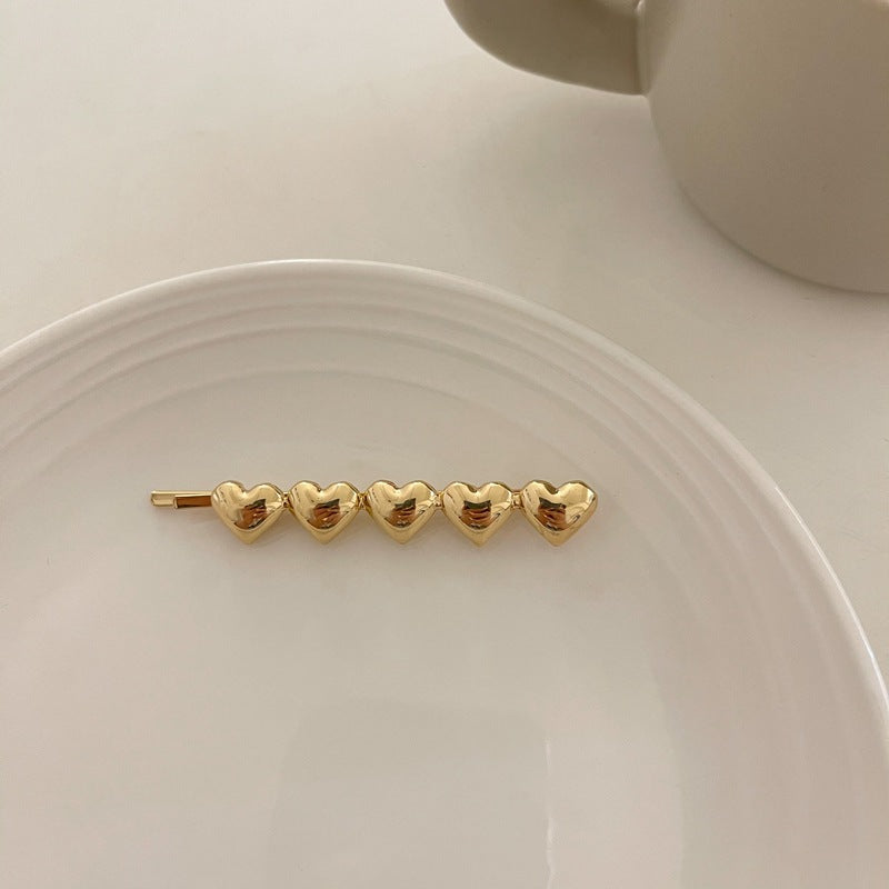 Metallic hearts hair slide