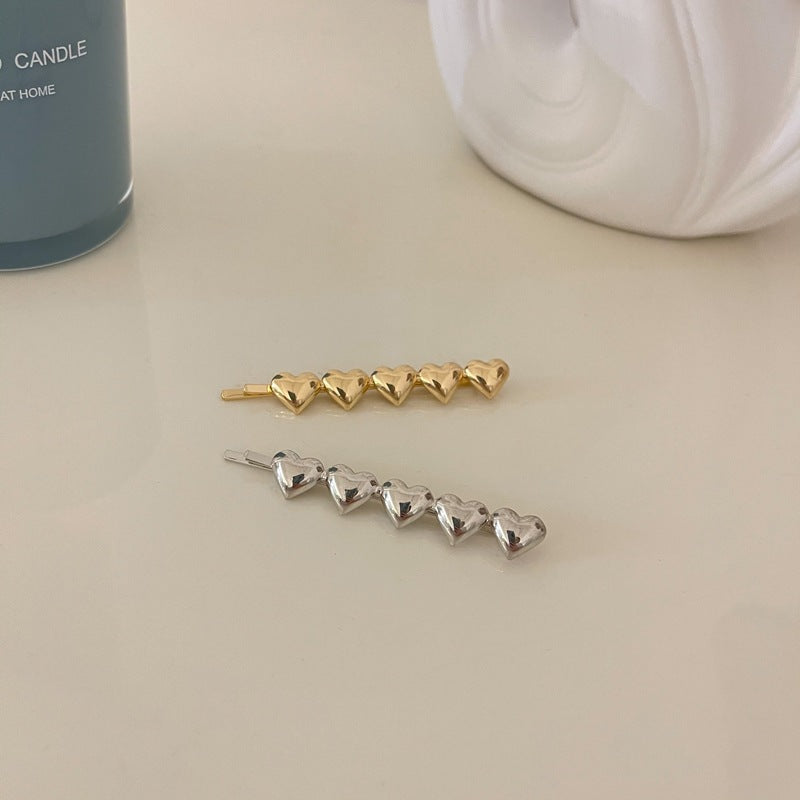 Metallic hearts hair slide