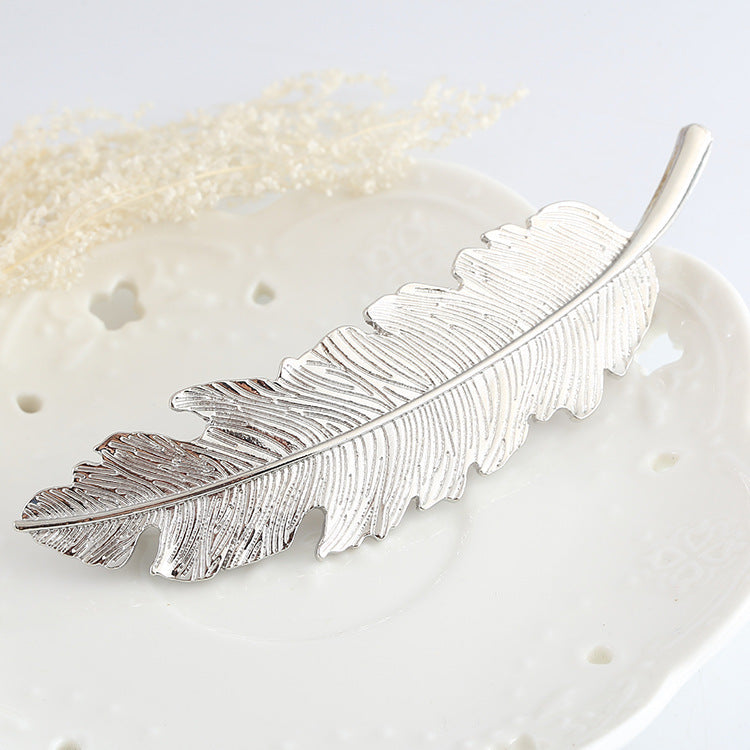 Large metallic feather hair barrette