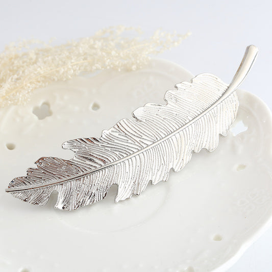 Large metallic feather hair barrette