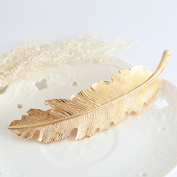 Large metallic feather hair barrette