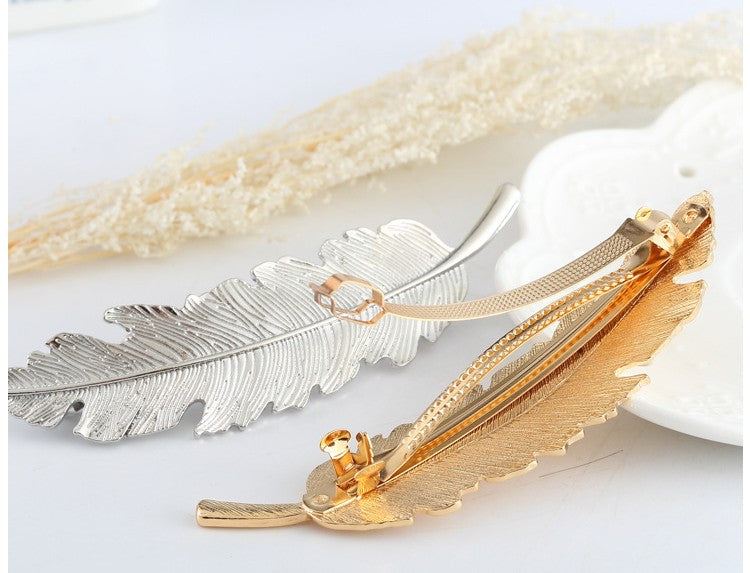 Large metallic feather hair barrette