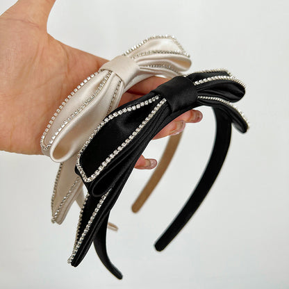 Silky satin headband with sparkling bow