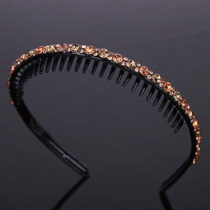 Rhinestone studded black acrylic headband with teeth