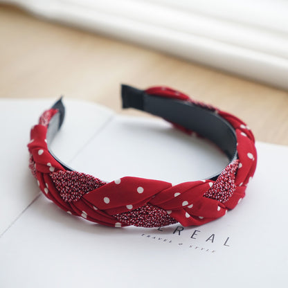 Braided top headband in mixed red polka dots