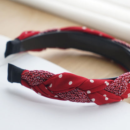 Braided top headband in mixed red polka dots