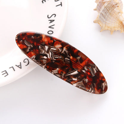 Flat oval resin hair barrette