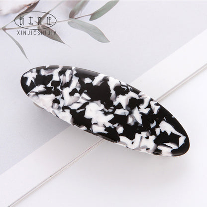 Flat oval resin hair barrette