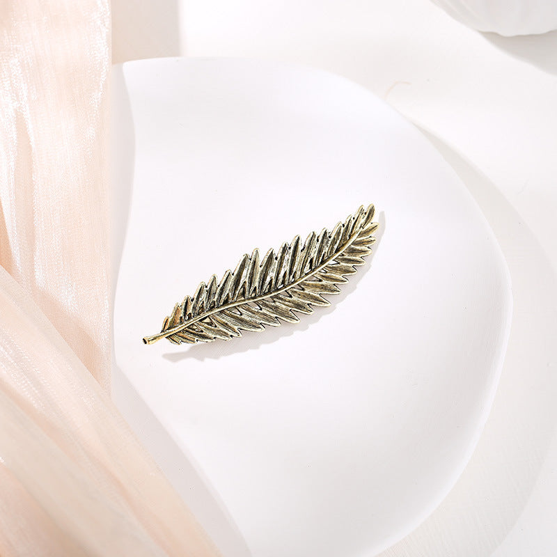 Metallic feather hair barrette