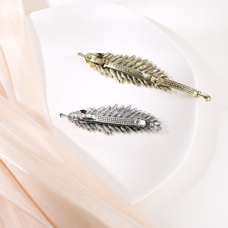 Metallic feather hair barrette