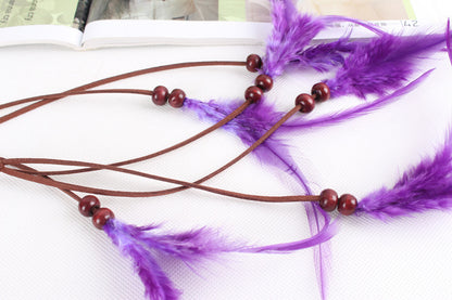 Braided brown suede band with purple feather hair tie