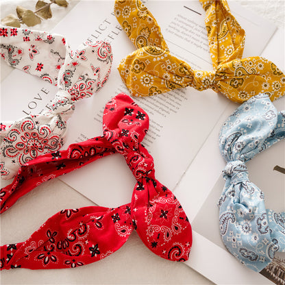 Multi-coloured paisley print elastic headband with bow