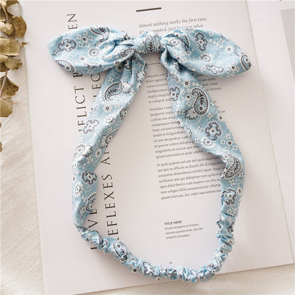 Multi-coloured paisley print elastic headband with bow