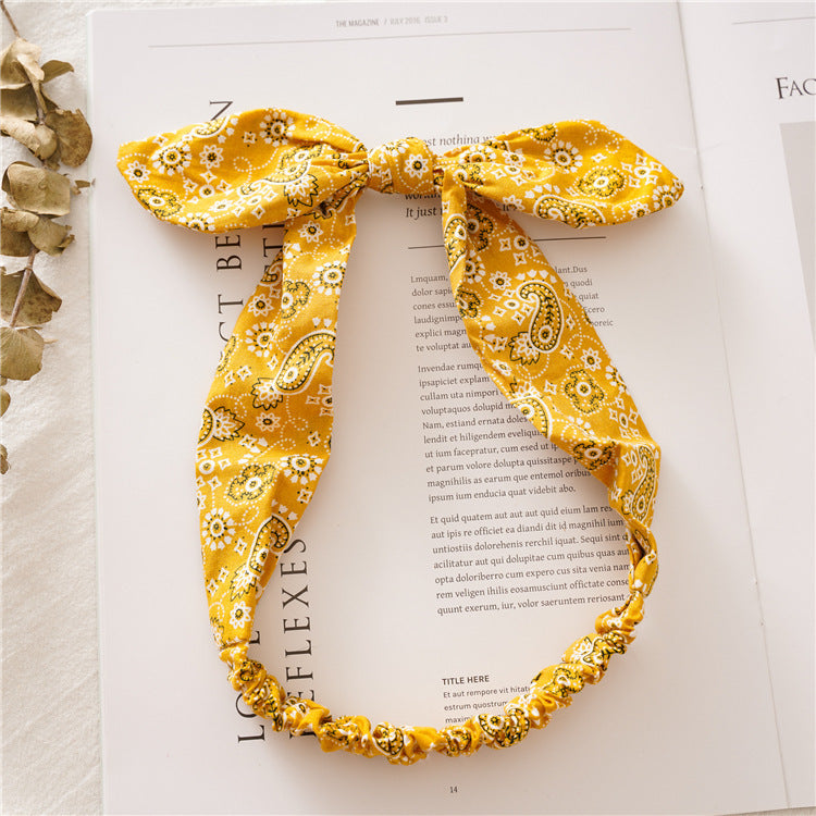 Multi-coloured paisley print elastic headband with bow