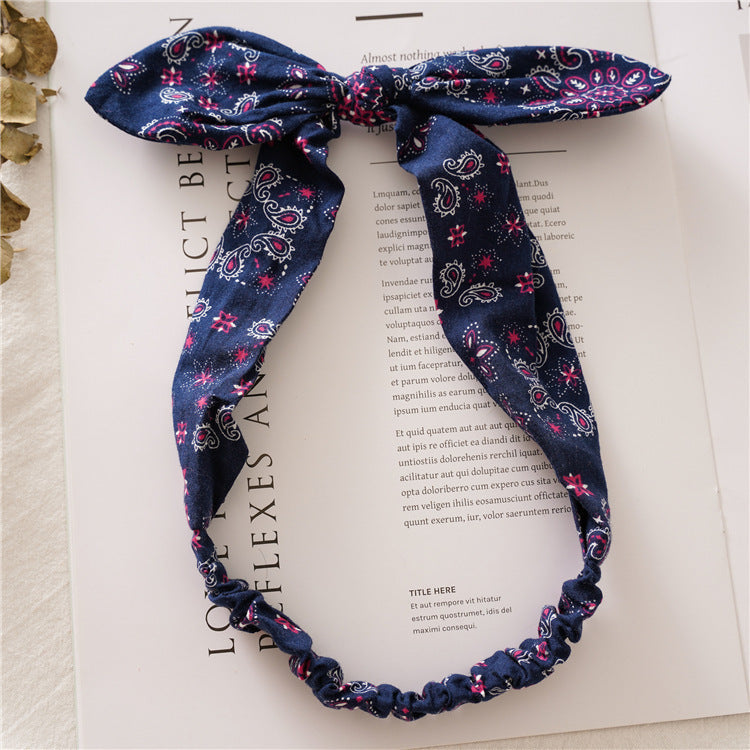 Multi-coloured paisley print elastic headband with bow