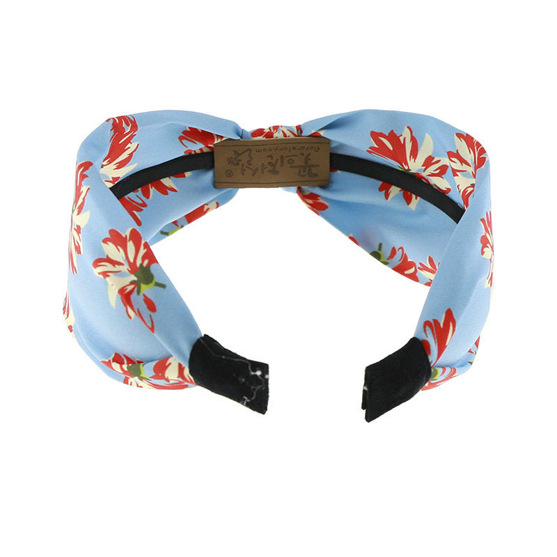 Sky blue knotted headband with red floral print